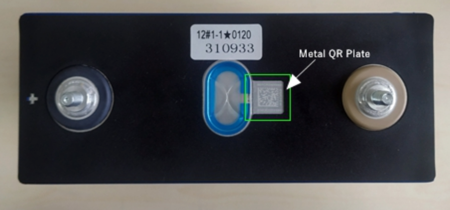 Physical LiFePO4 cell top showing terminals, safety vent and metal QR plate